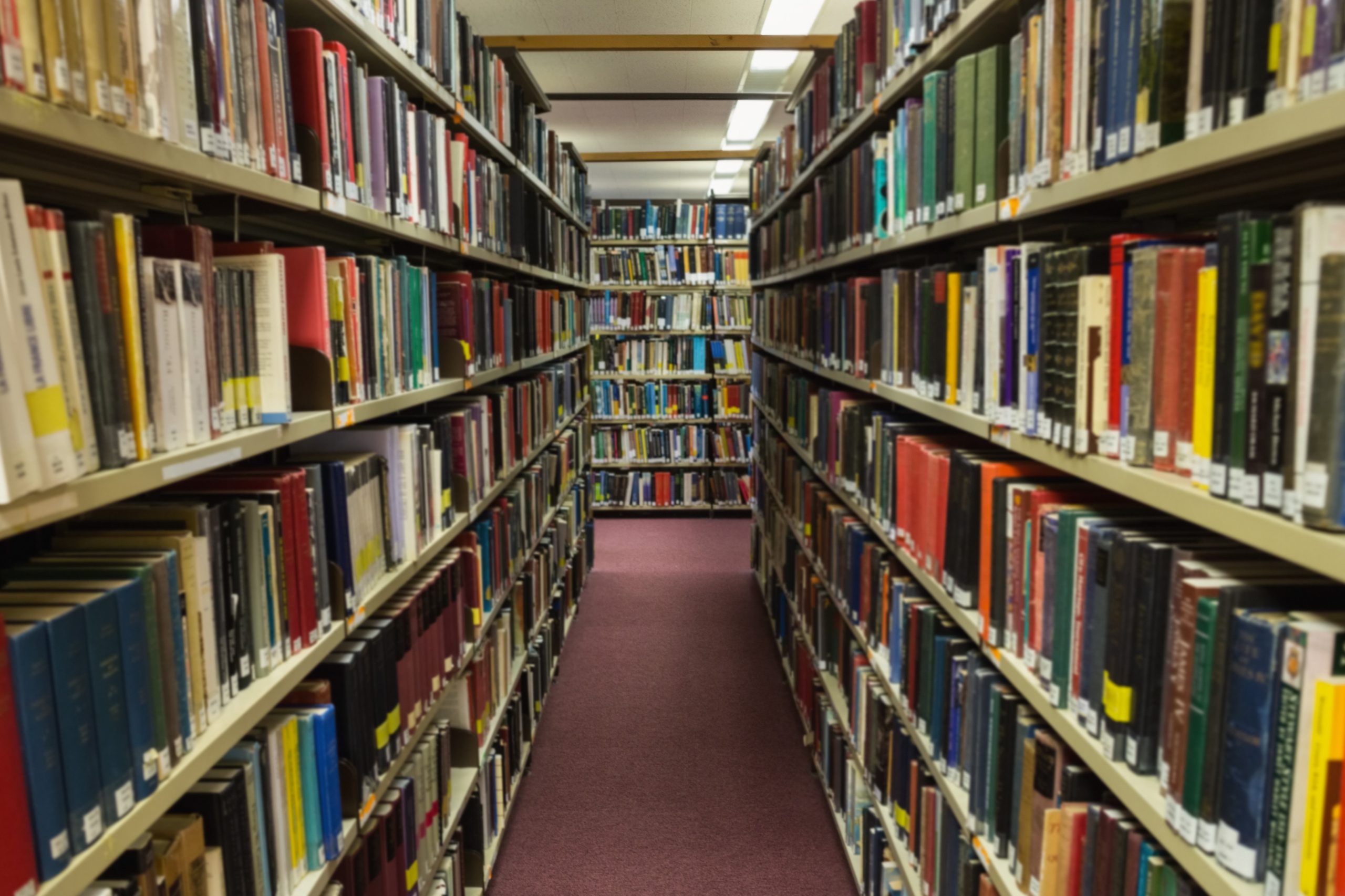 volumes books bookshelf library scaled